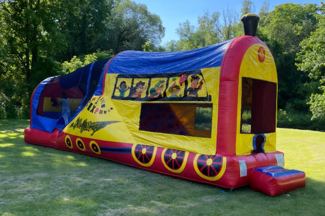 Train 3-in-1 Combo bouncy castle set up on grass at a sunny park