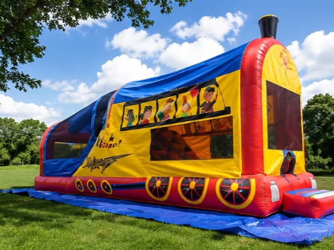 Train 3-in-1 Combo bouncy castle set up on grass at a sunny park