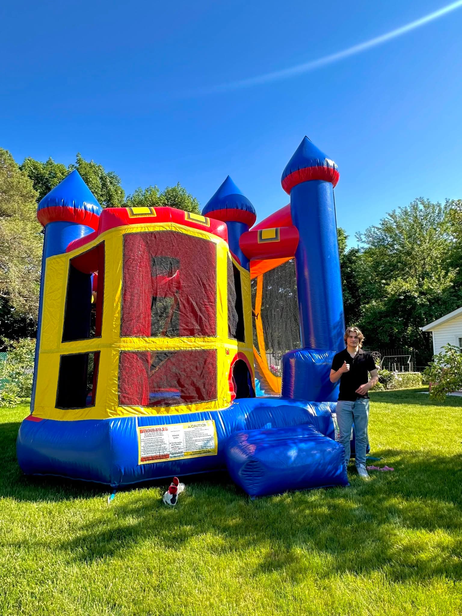 Classic blue, red and yellow castle bouncer on a sunny day